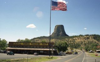 Devil's Tower with tourist shop and American flag