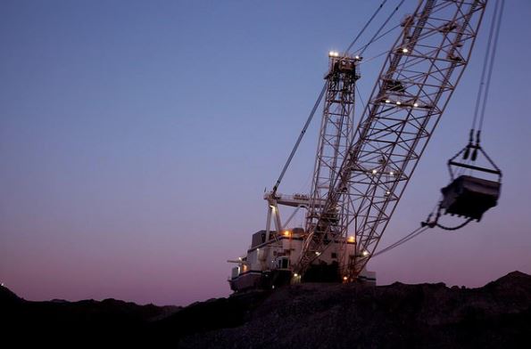 An Excavator works at twilight