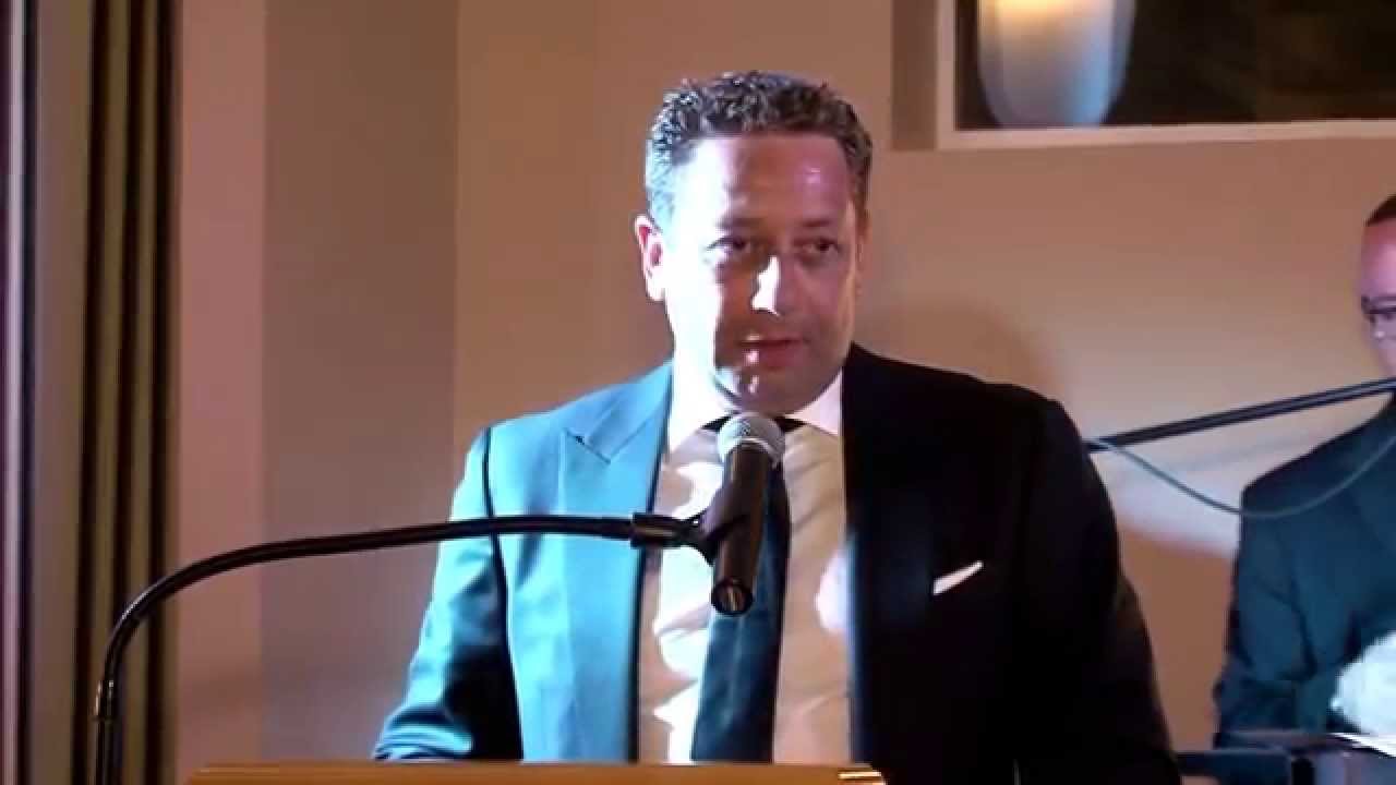 Felix Sater speaking at a podium.