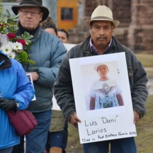 Photos by Tom Rivers – Daniel Larios Hernandez holds a picture of his son, Luis Daniel Larios Hernandez, in a march on Main Street in Albion to raise awareness about the dangers of working on farms. The march followed a vigil at the Presbyterian Church in honor of Luis and other farmworkers who died on the job.