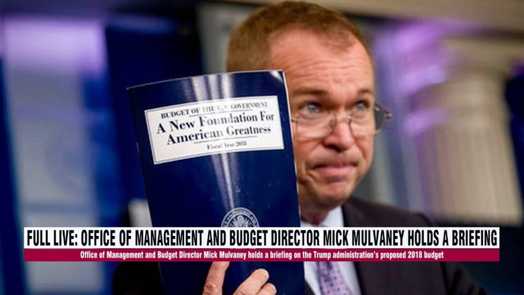 Picture of Mick Mulvaney with a copy of the federal budget.