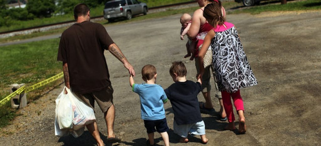 a low income family walks home.