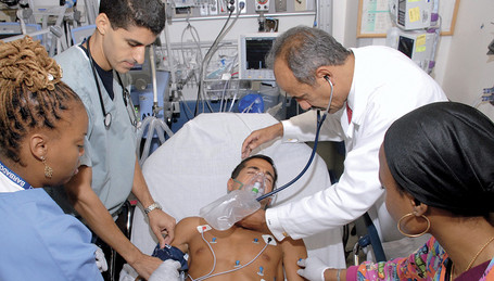 Healthcare: Doctors and Nurses treat a patient in a hospital