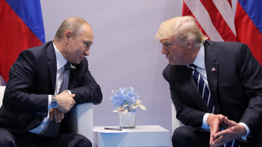 Putin Leans over to speak with Donald Trump