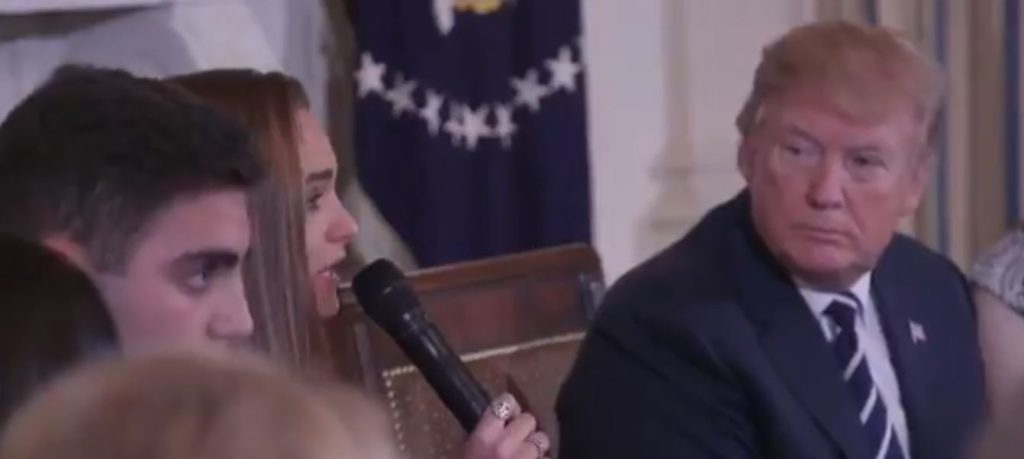 Trump listening to student speak about gun violence.