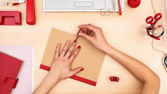 A woman painting her nails.