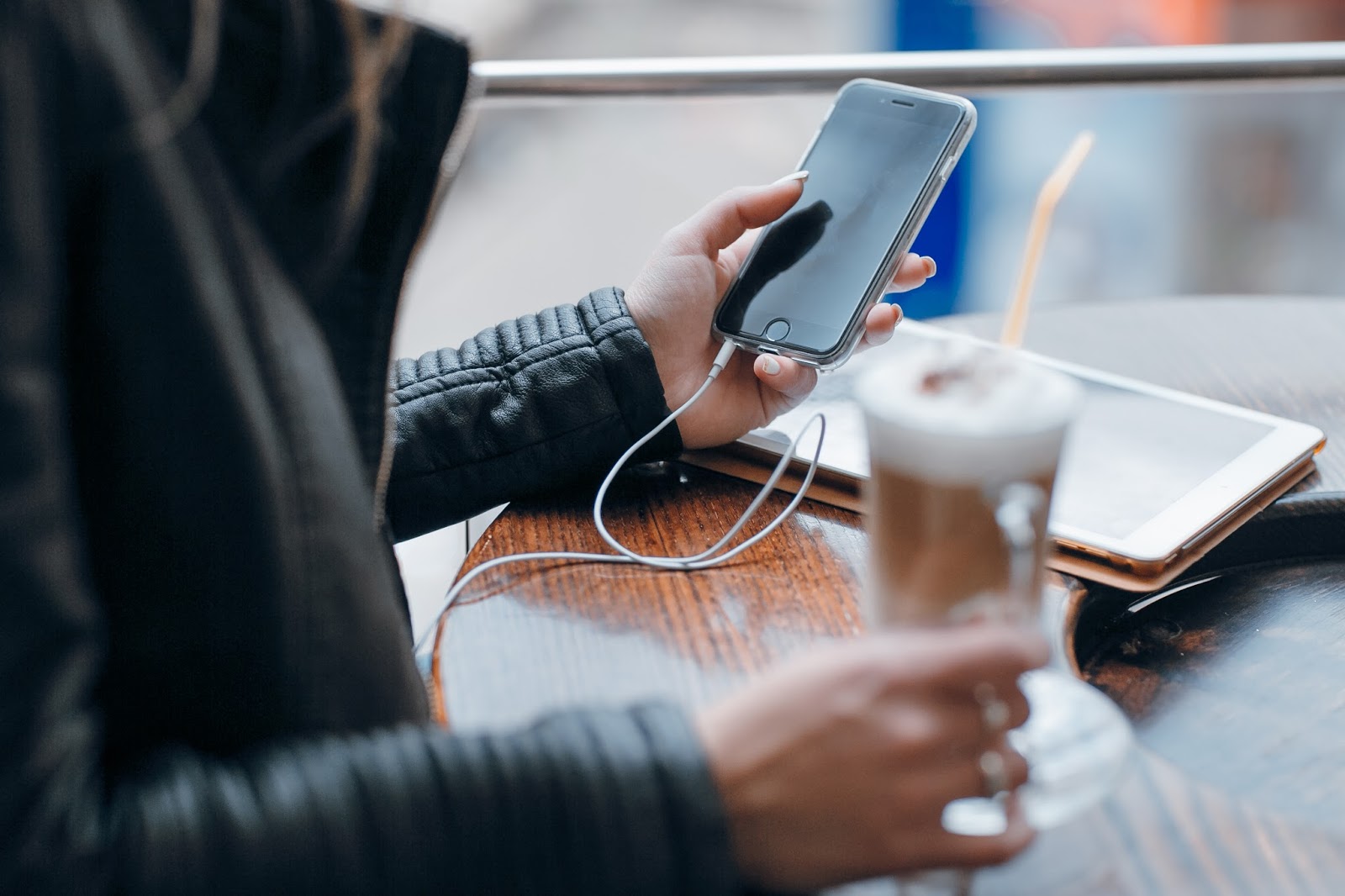 A person checks their phone in a coffee shop