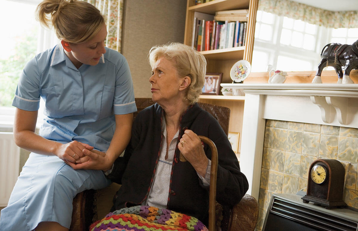 Home Healthcare Workers with an elderly female patient
