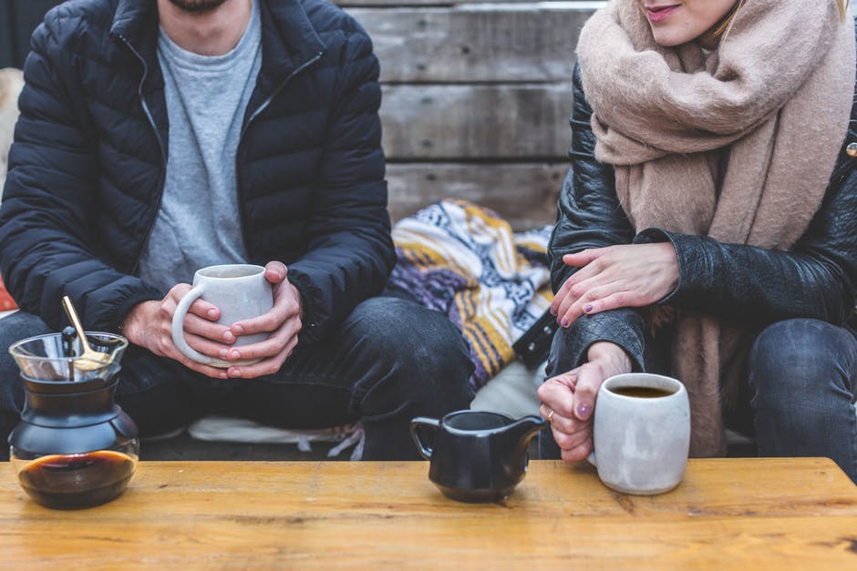 Two people enjoy a cup of coffee.