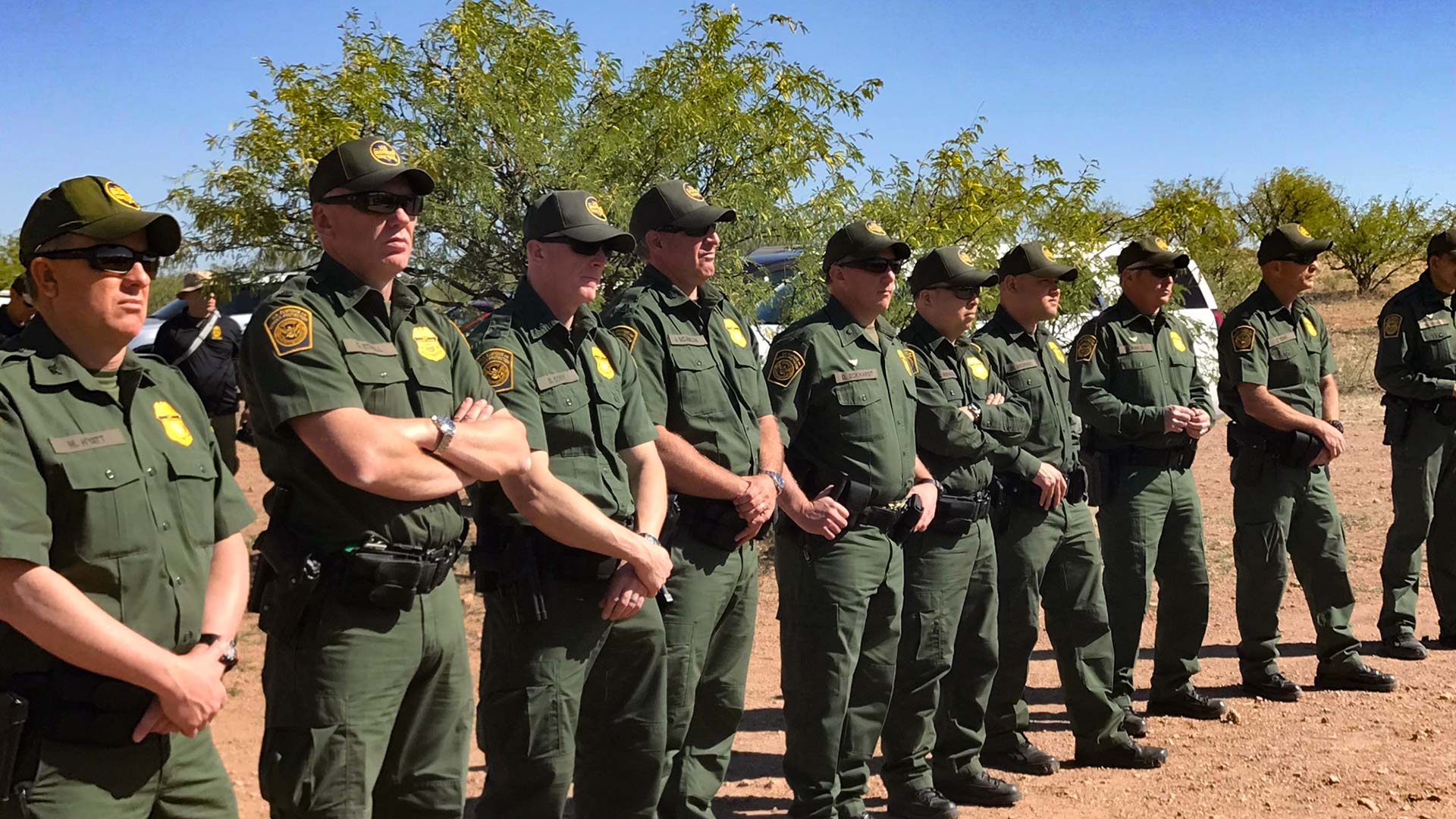 Border Patrol Agents in a line.