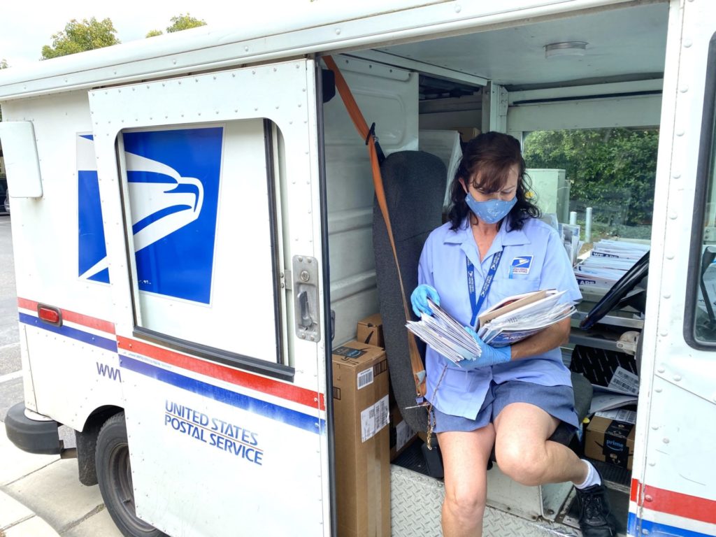 The Post Office: a postal worker delivers mail.