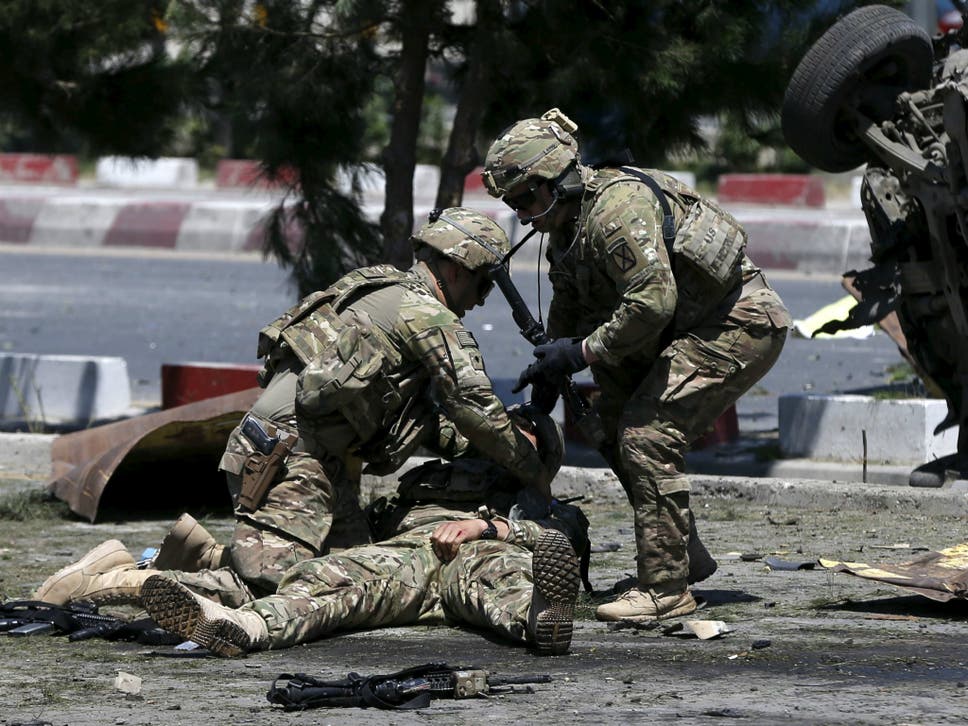 Russian Bounty: U.S. soldiers attend to a wounded soldier at the site of a blast in Kabul, Afghanistan in June of 2015. ( REUTERS/Omar Sobhani )