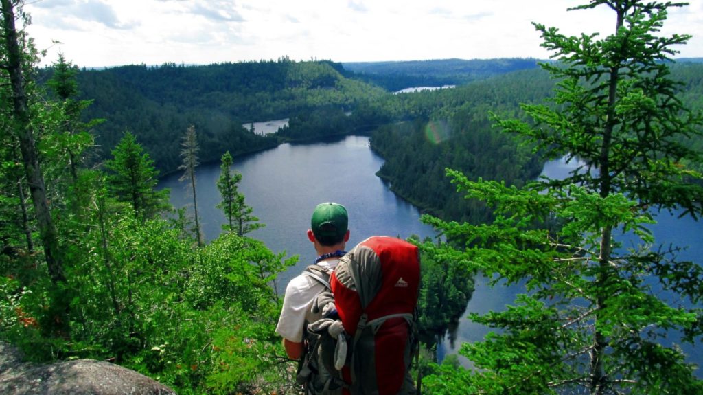 Boundary Waters Wilderness: a hiker admires the view of a river
