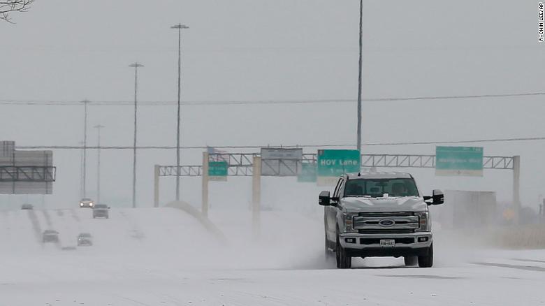 Vehicles driving on snow-covered Interstate 10 Monday, Feb. 15, 2021, in Houston. A winter storm making its way from the southern Plains to the Northeast is affecting air travel. (Yi-Chin Lee/Houston Chronicle via AP)