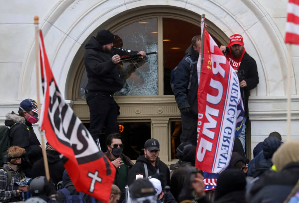 Pathology: A man breaks a window as a mob of supporters of U.S. President Donald Trump storm the U.S. Capitol Building in Washington, U.S., January 6, 2021. REUTERS/Leah Millis/