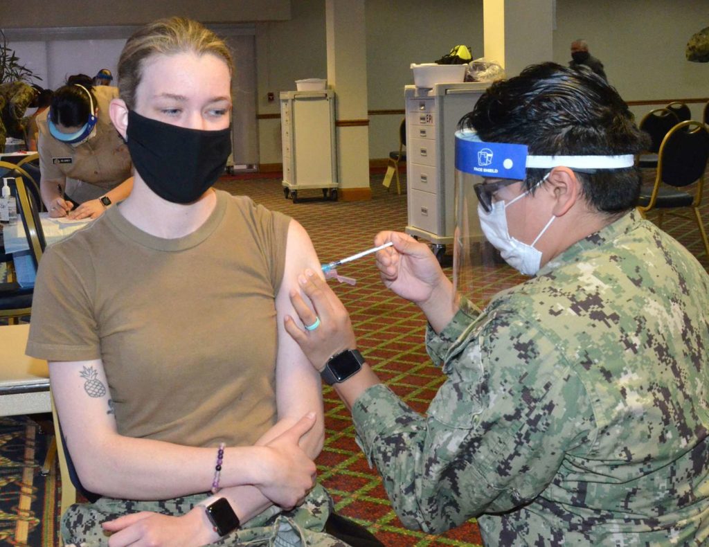 Administering covid vaccine to a soldier