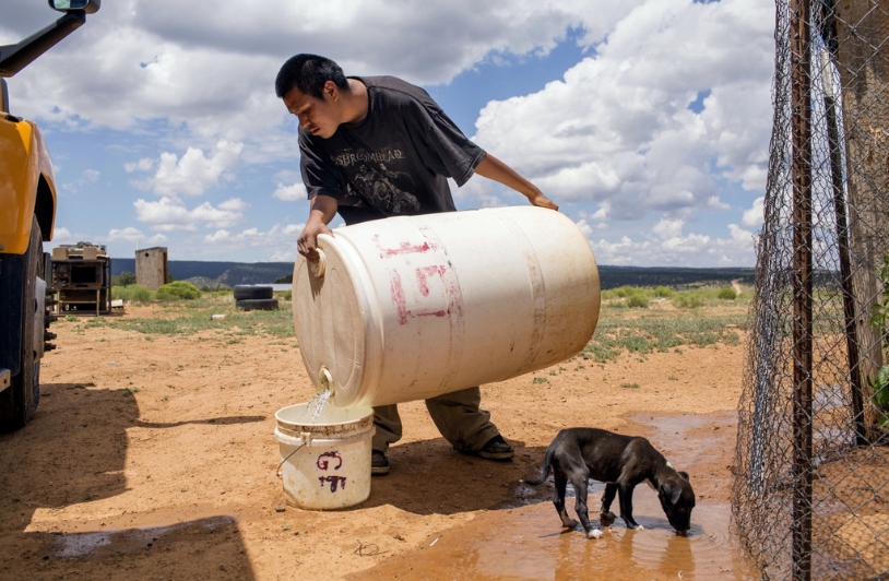 Man and dog with scarce water on Navajo Nation