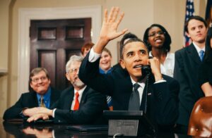 President Barak Obama on the telephone in an office.