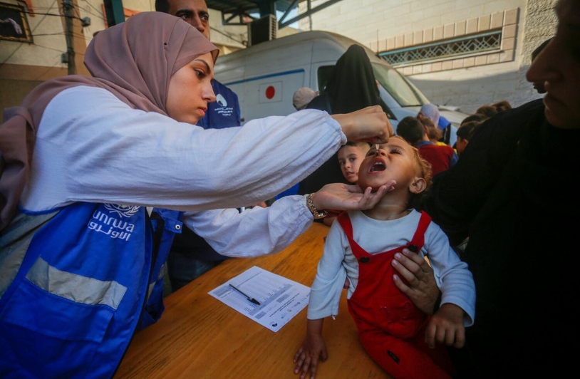 Gaza, Aid and Practicality woman helping a young child in Gaza