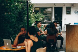 Friends in a restaurant discussing topics.