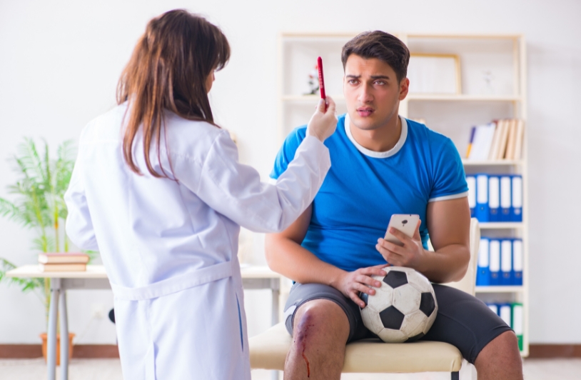 doctor checking for sports concussion