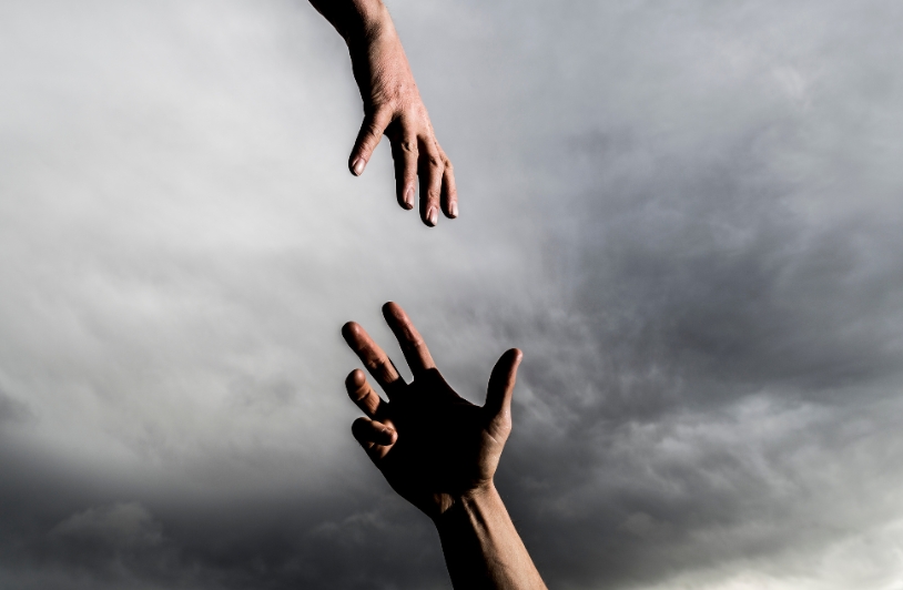 Two hands reaching for each other