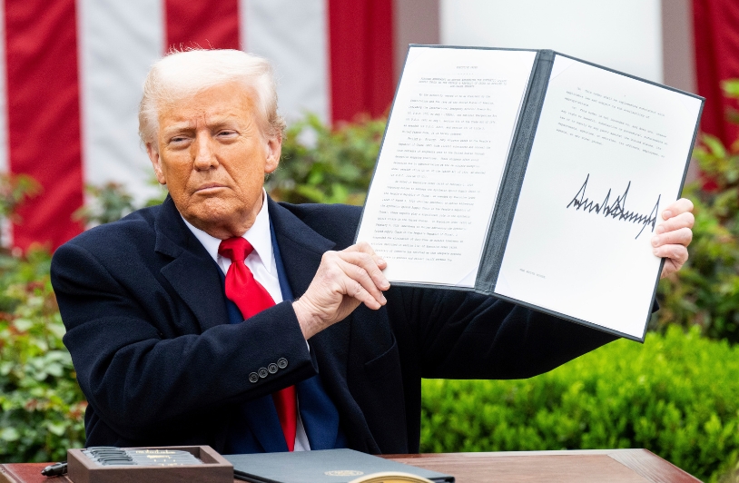 Donald Trump holds up executive order on his Liberation Day.