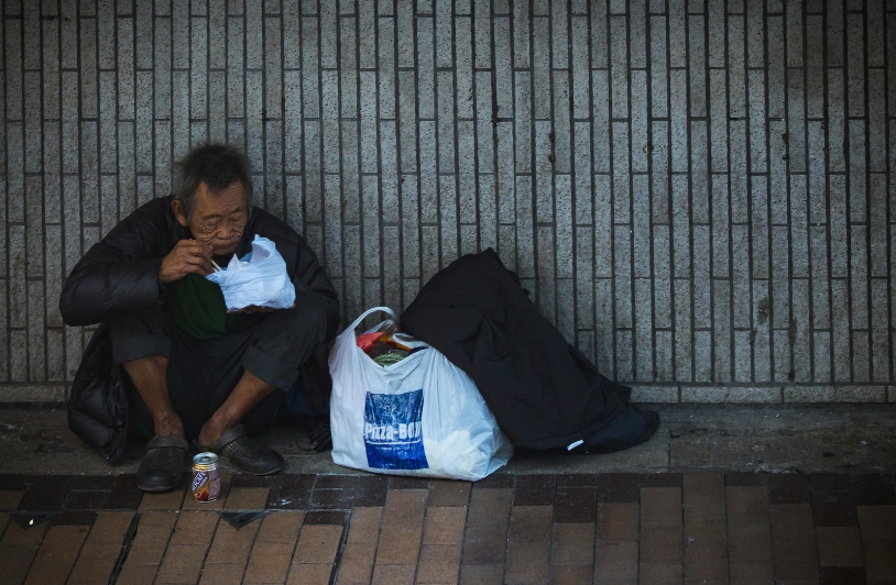 Empowering Change: Strategies for Combating Drug Abuse Among the Homeless Homeless man eating outside of a building.