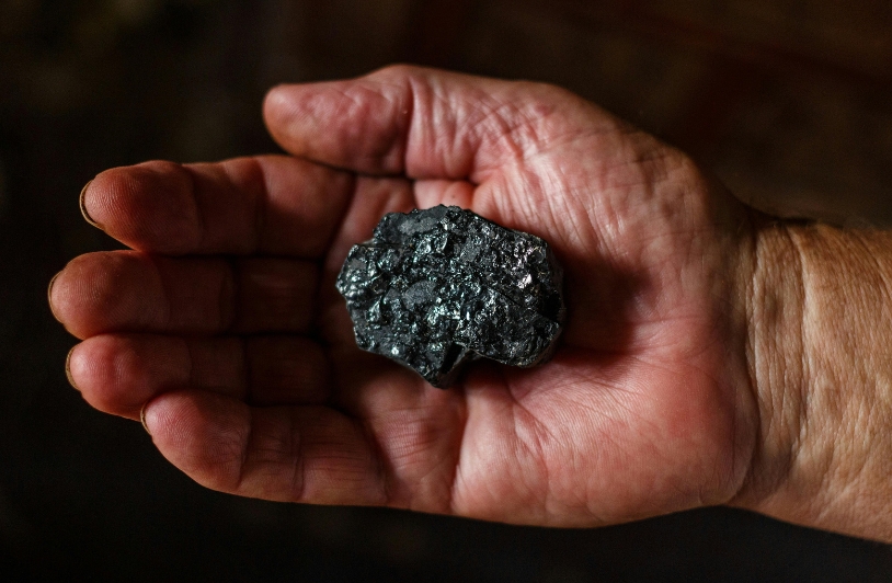 A hand holding coal