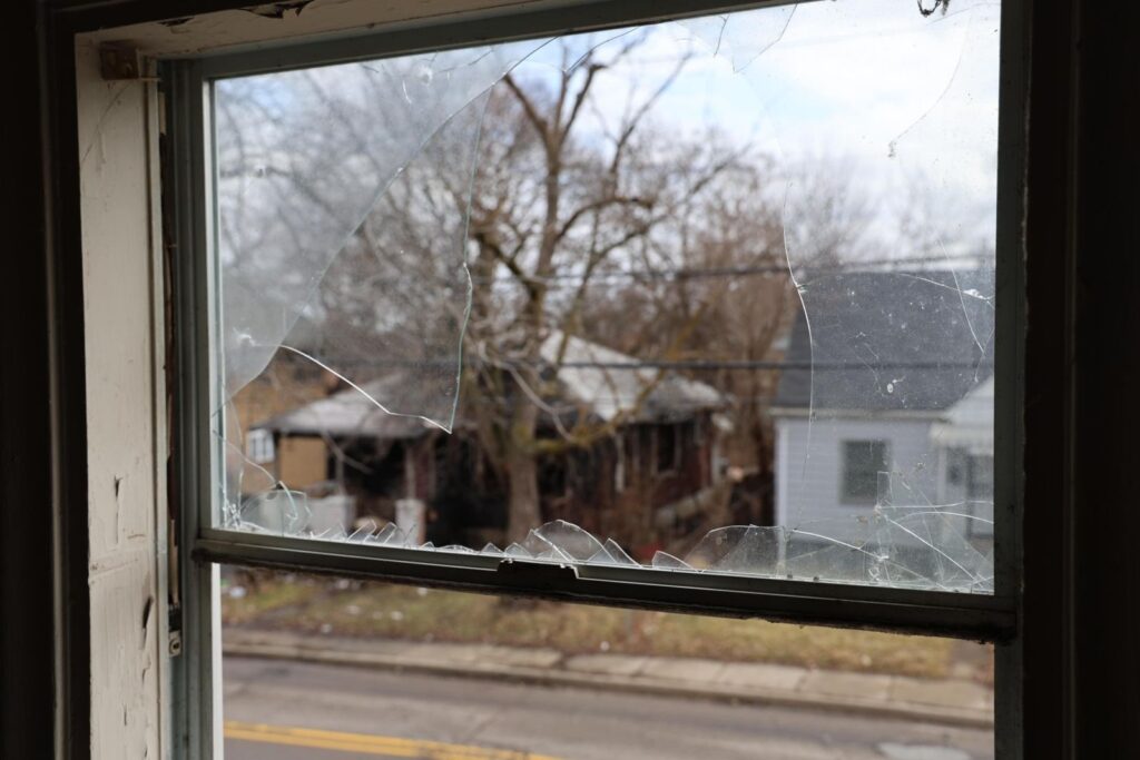Broken window at abandoned house in Flint, Michigan.