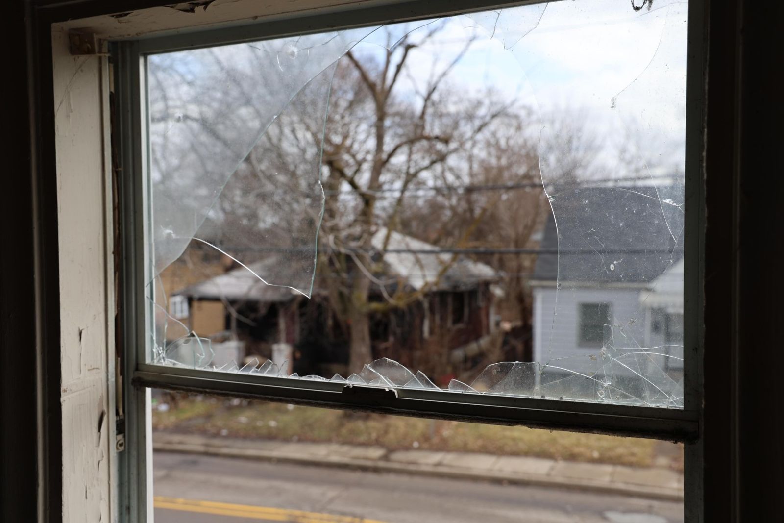 Broken window at abandoned house in Flint, Michigan.