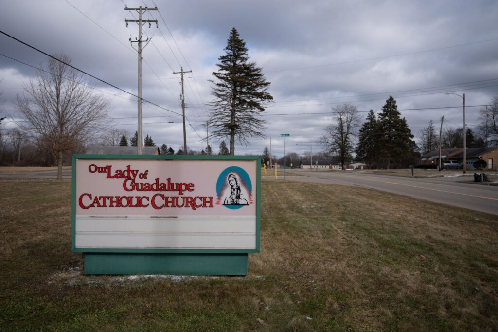 The exterior signage of Our Lady of Guadalupe Church, located just outside of Flint in Beecher, Michigan. 