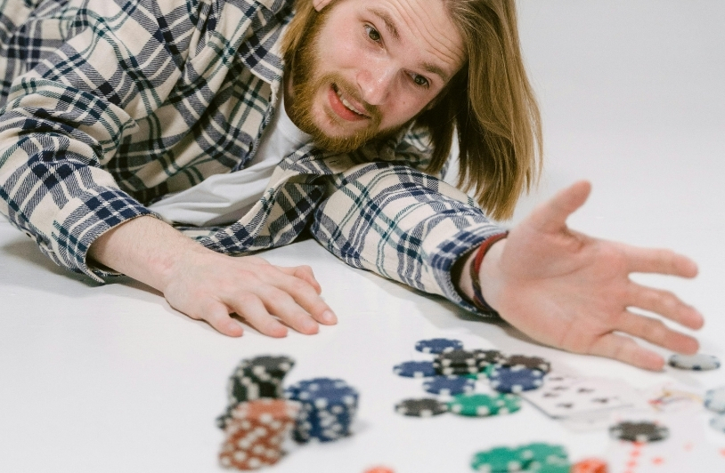 A Man Lying on a Floor with Poker Chips