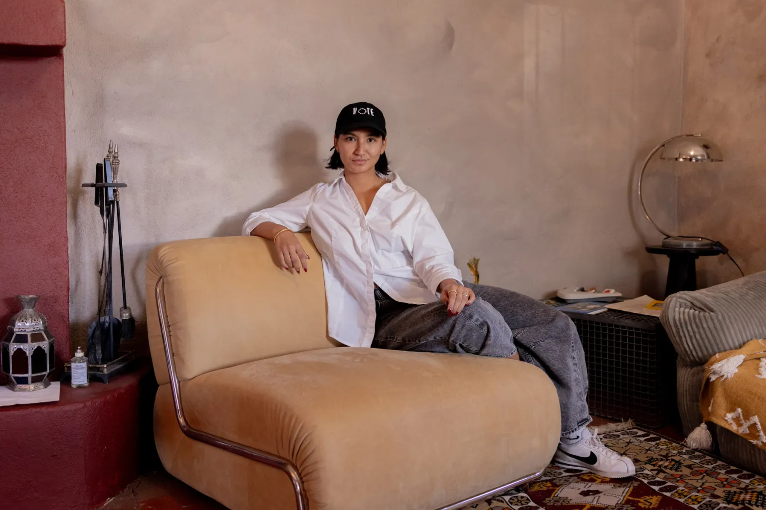 Deja Foxx sitting on a couch