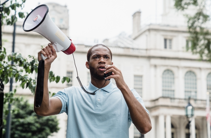 Strategy for Democratic VOTERS to Succeed man with megaphone