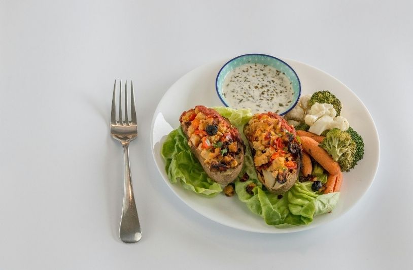 Toasts with Vegetables and Dip Served on White Plate