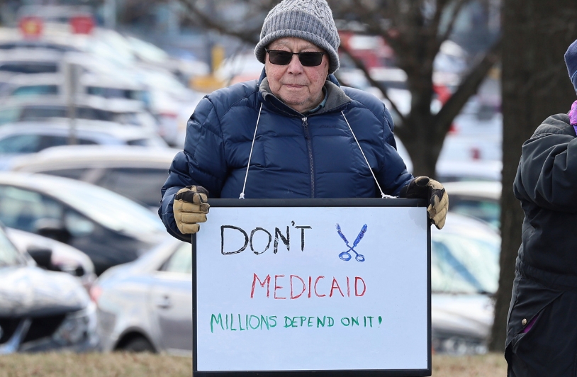 woman protesting cuts to Medicaid