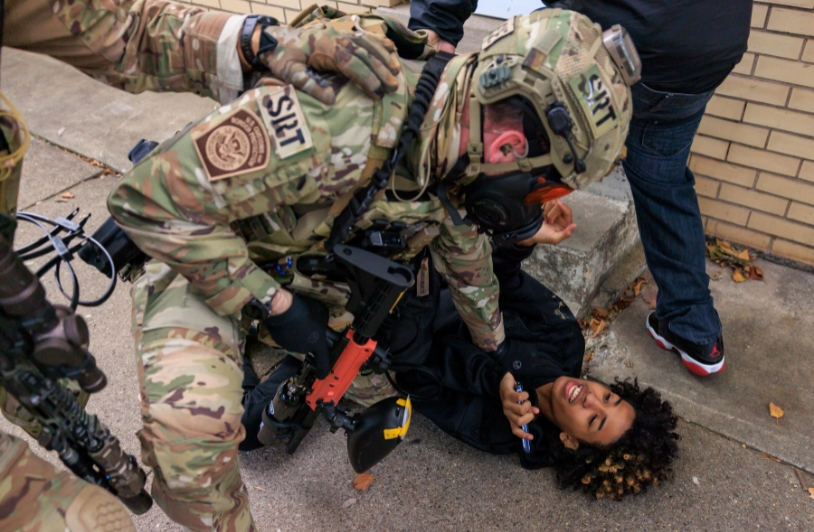 A U.S. Customs and Border Protection agent detains a protester