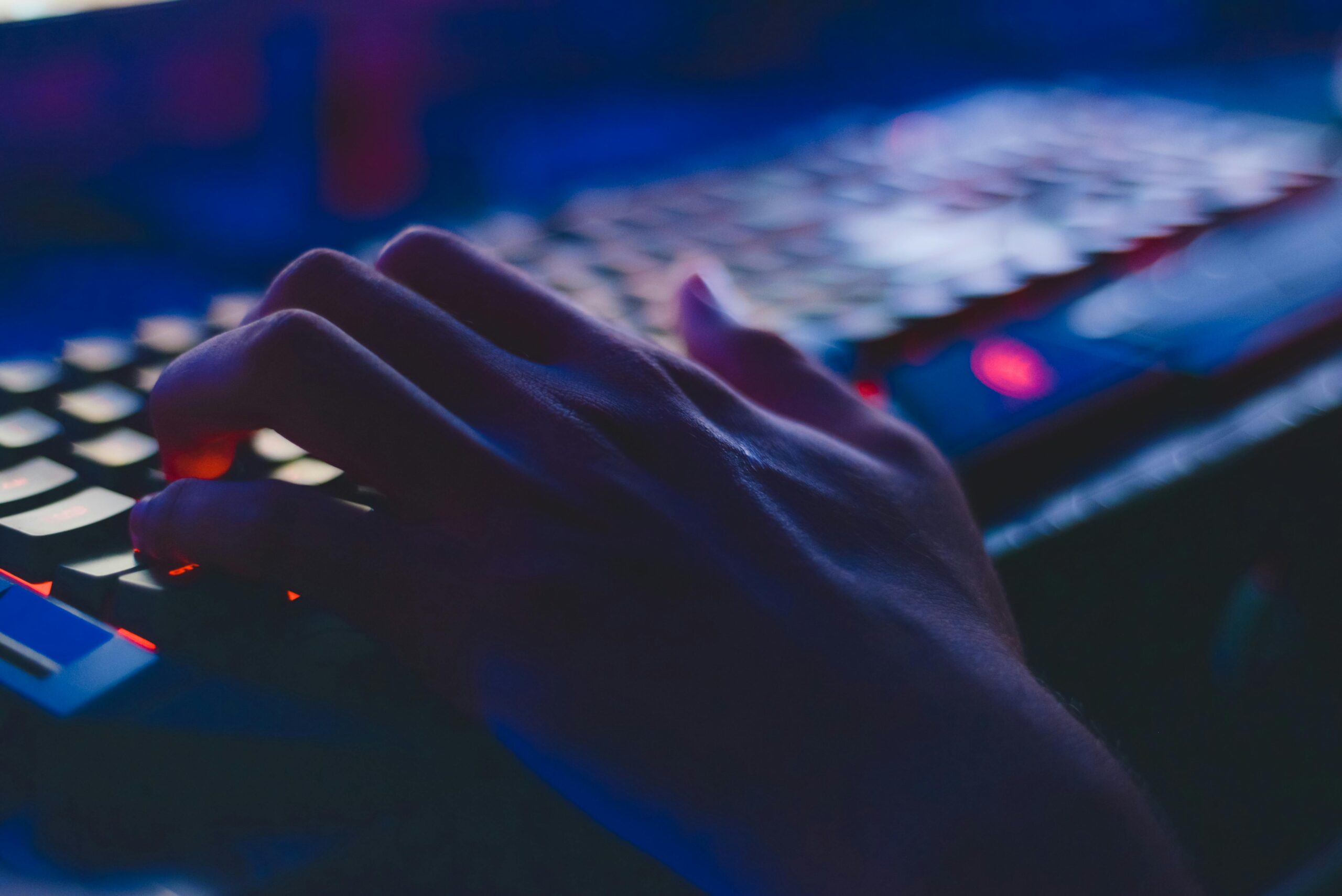 Hand on a dark keyboard