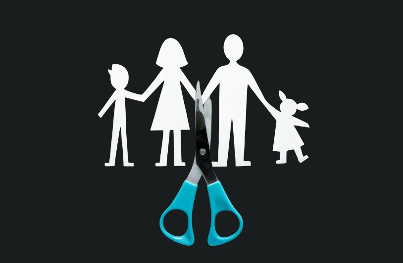 paper cutout of family split by divorce