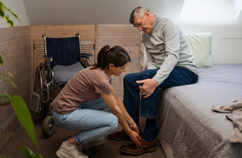 Elderly person being taken care of by female caretaker