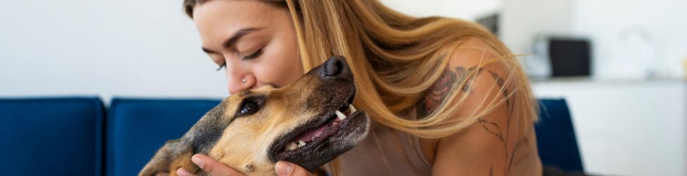 Complete Pet Care Solutions for Healthy, Happy Pets Medium shot woman kissing dog