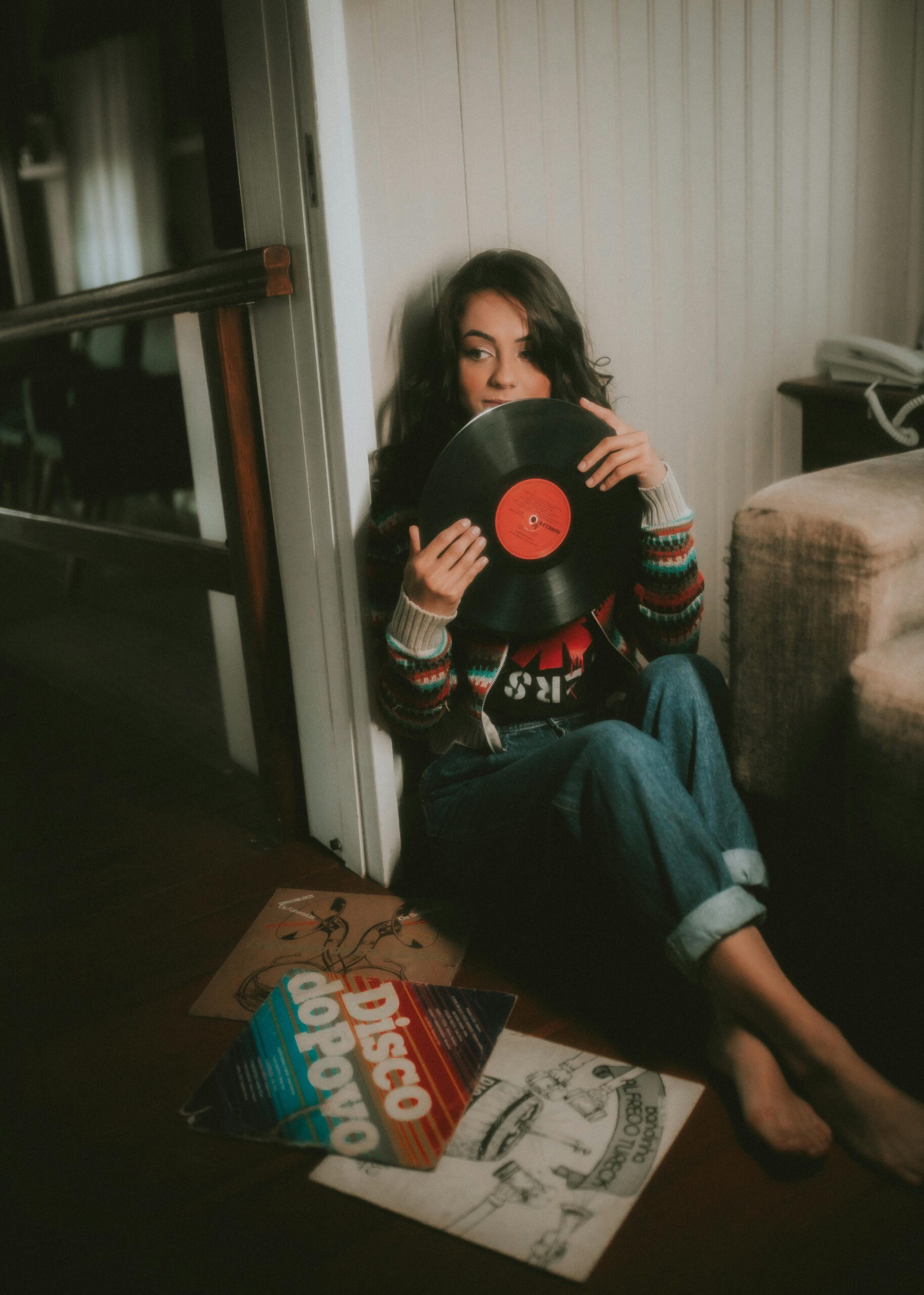 Woman Sitting on Floor and Holding Vinyl Disk