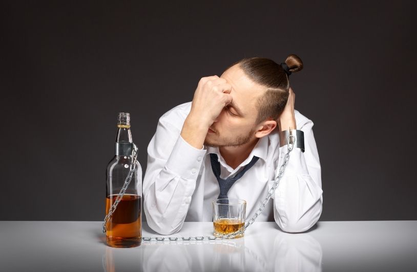 Five Signs Alcohol Is Having an Impact on Your Liver Pensive worker with chains