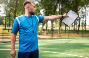 Football coach teaching his students