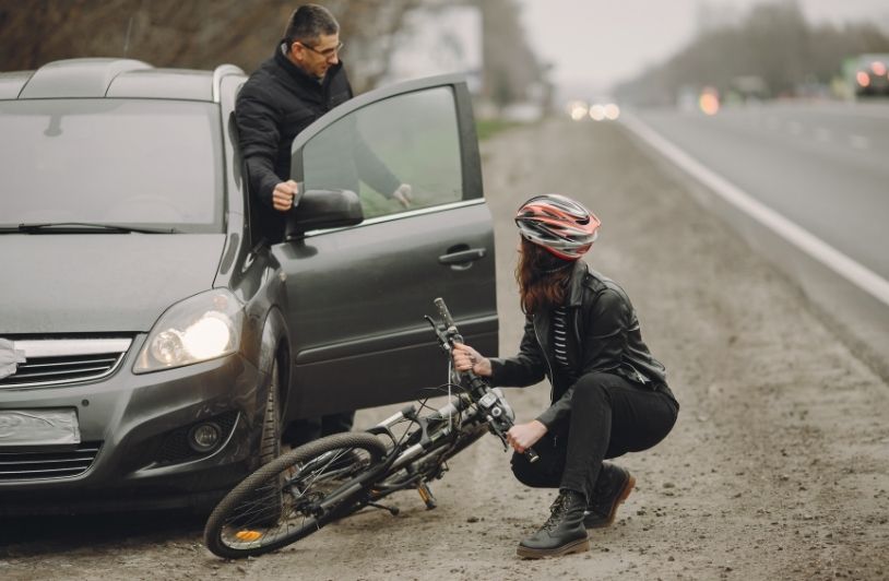 The woman crashed into the car. Girl in a helmet.