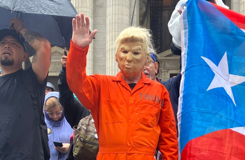 No Kings protestor dressed as Trump in prison suit.