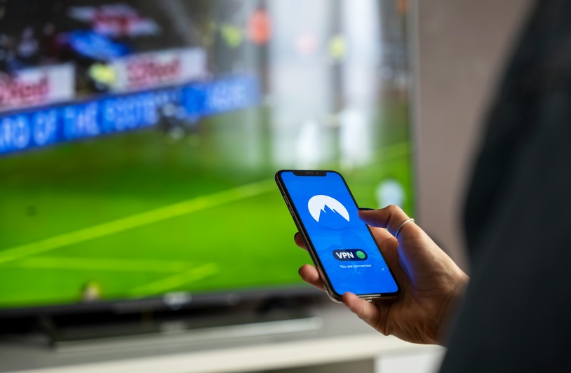 Is Gambling Legal in DC and What Bettors Should Know Before They Play Person holding smartphone, sports gambling