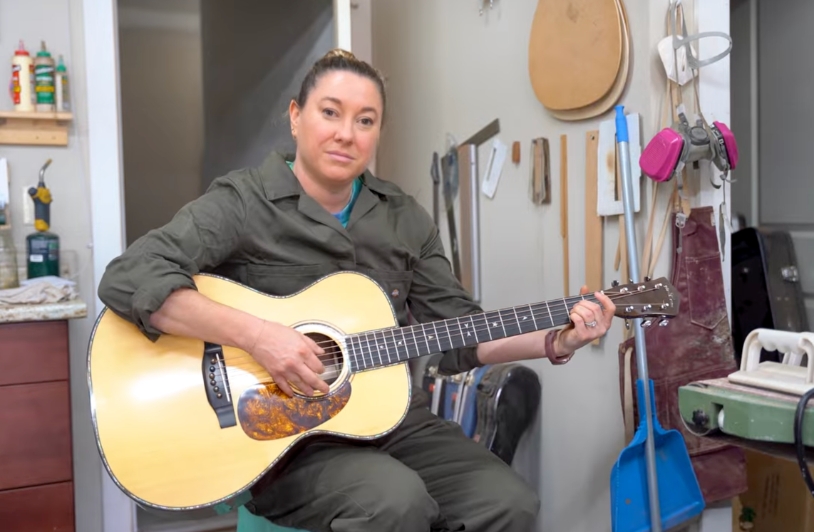 Jayne Henderson playing a guitar