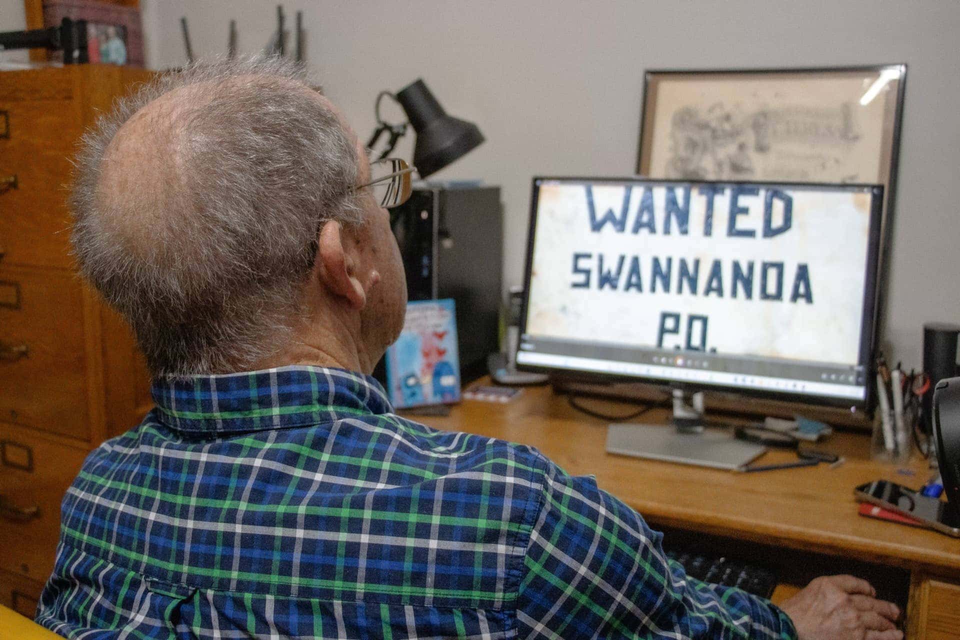 man looking at computer screen